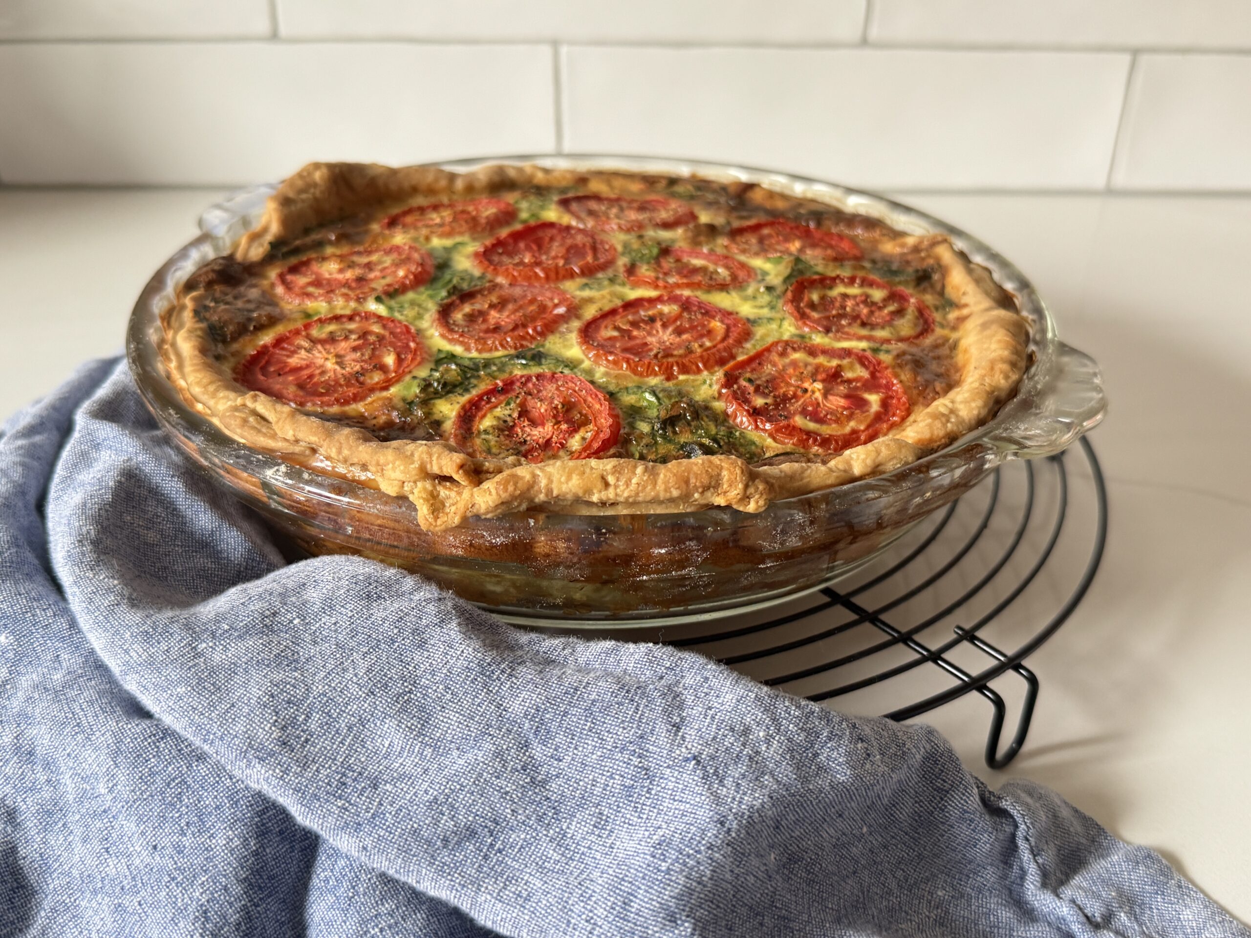 finished quiche baked horizontal with blue napkin