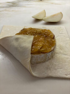 folding puff pastry over top of brie