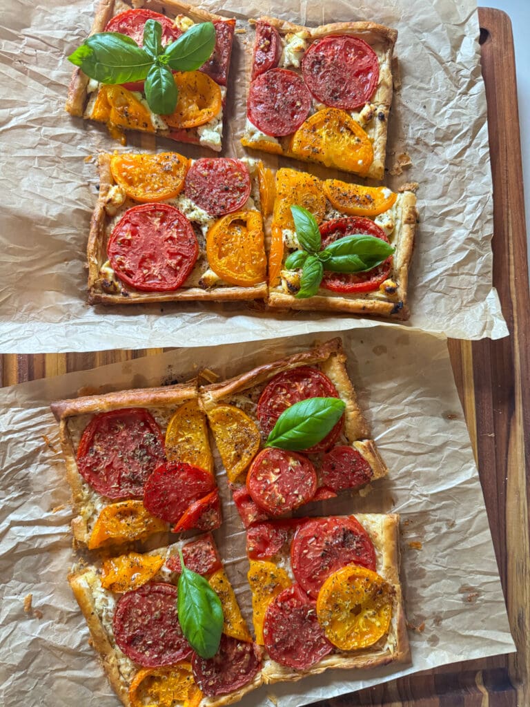 Two goat cheese tomato tarts on parchment