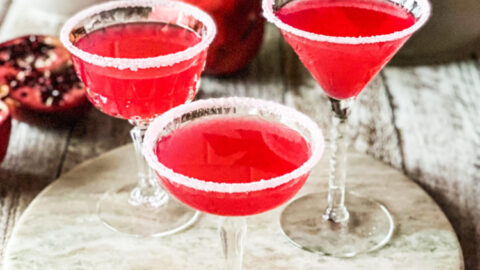 3 pomegranate lemon drop martinis with sugar dusted glasses