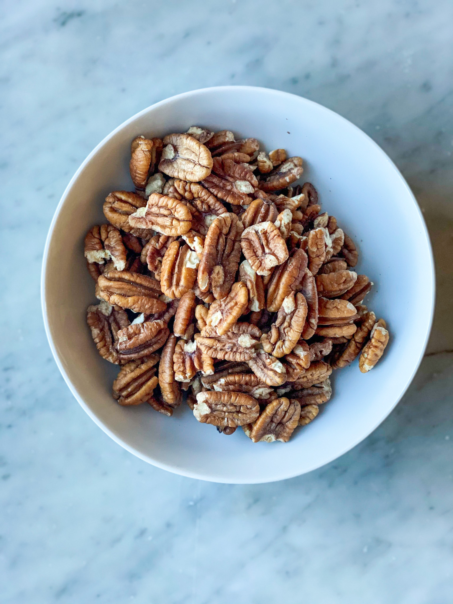 white bowl of pecans