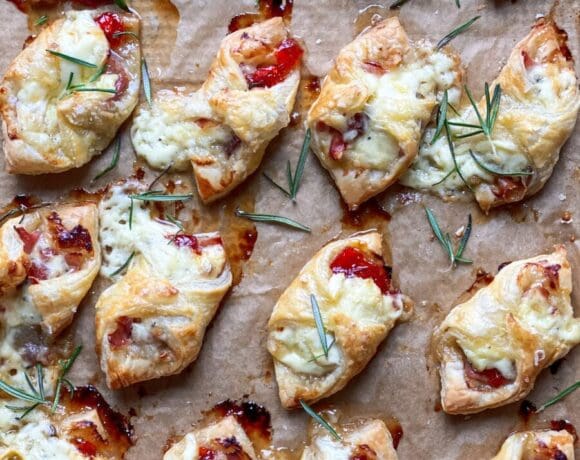 Baked brie with prosciutto and pepper jelly in puff pastry.