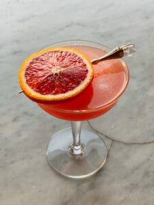 Citrus martini with blood orange garnish with a jeweled cocktail pick