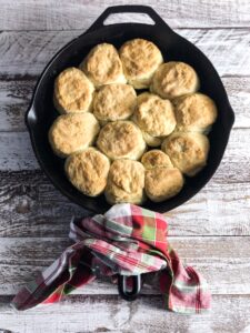 biscuits in a cast iron pan and a red and green napkin