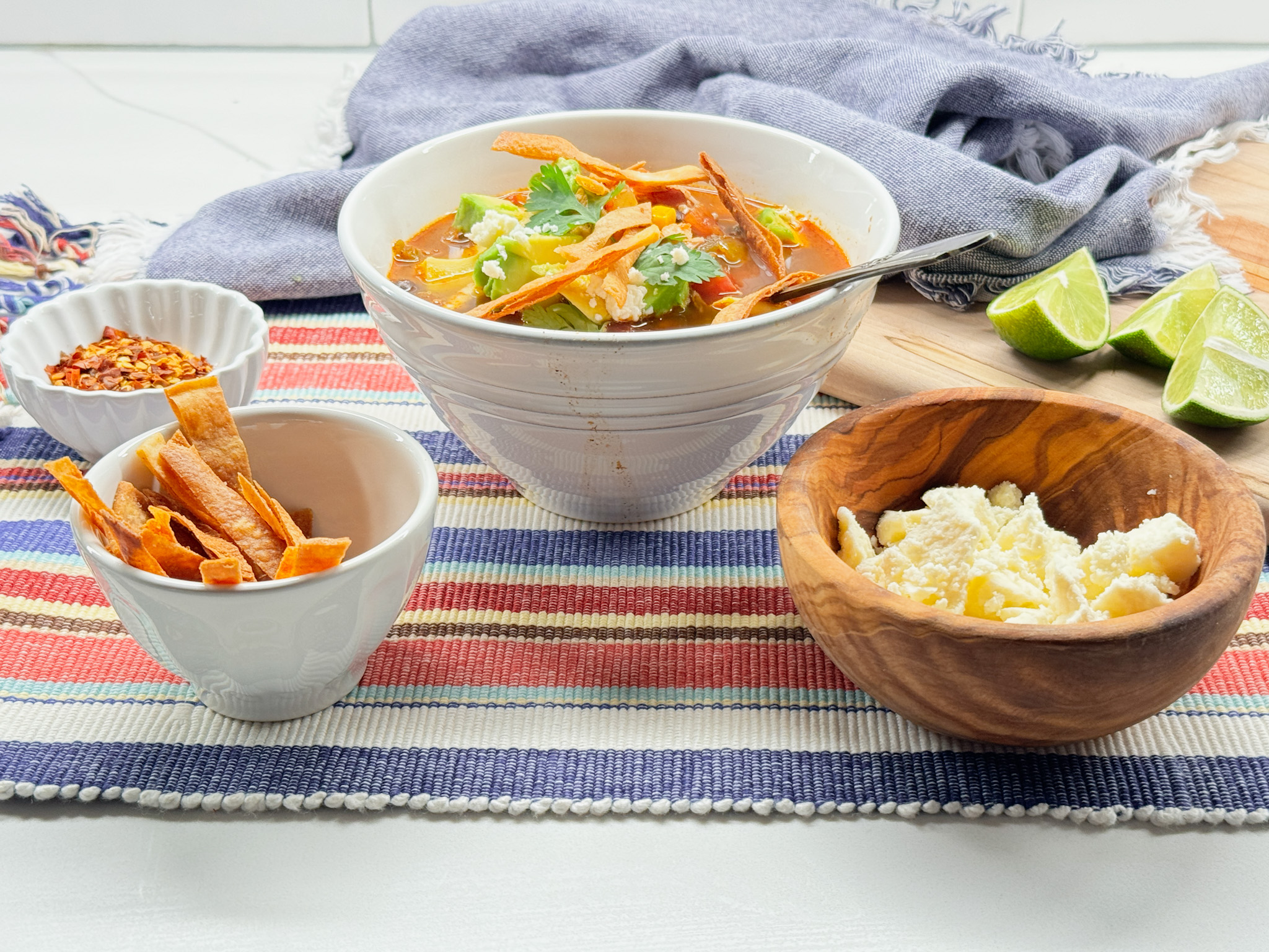 tortilla chicken soup with limes, hot pepper flackes , cheese, tortilla chips