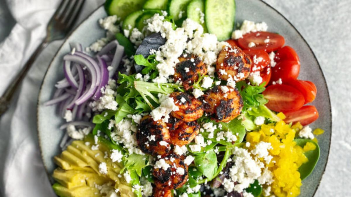 Greek salad with onions, cucumbers, feta, shrimp, and tomatoes