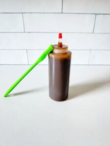 bourbon caramel sauce in a squirt bottle with a pastry brush