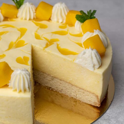 mango mouse cake with a slice out of it