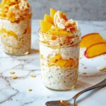 Tropical overnight oats in 2 jars with a spoon