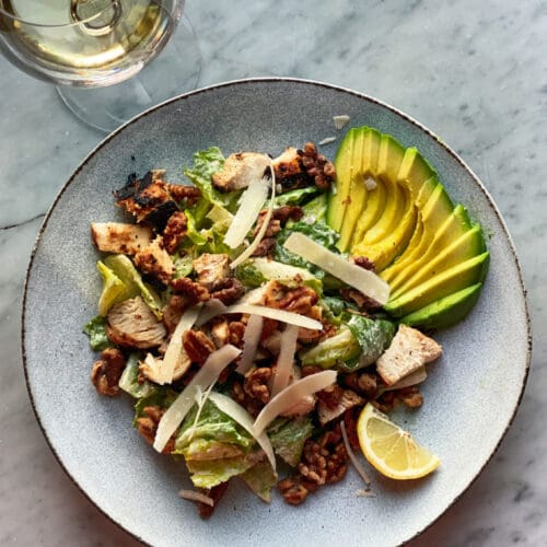 Caesar salad with avocado and walnuts and chicken