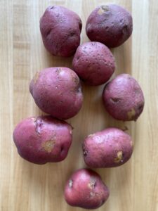 red potatoes on a cutting board