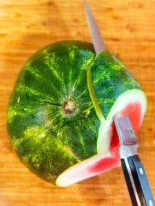 Watermelon with a knife slicing it