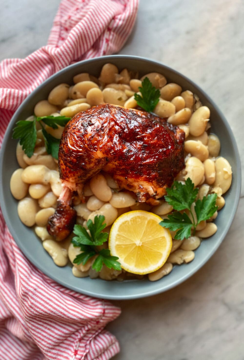 beer can smoked chicken with beans and a lemon