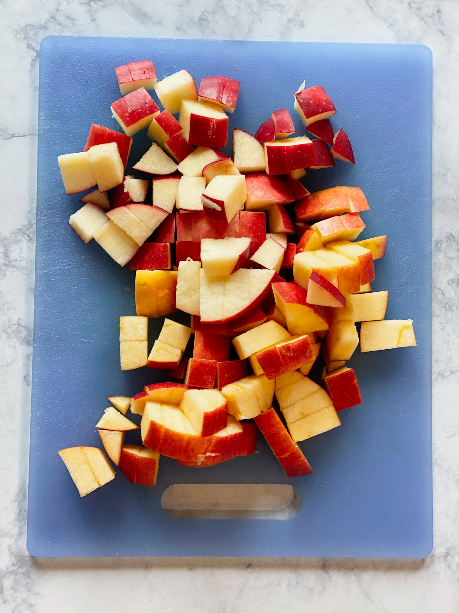 chopped red apple on a cutting board