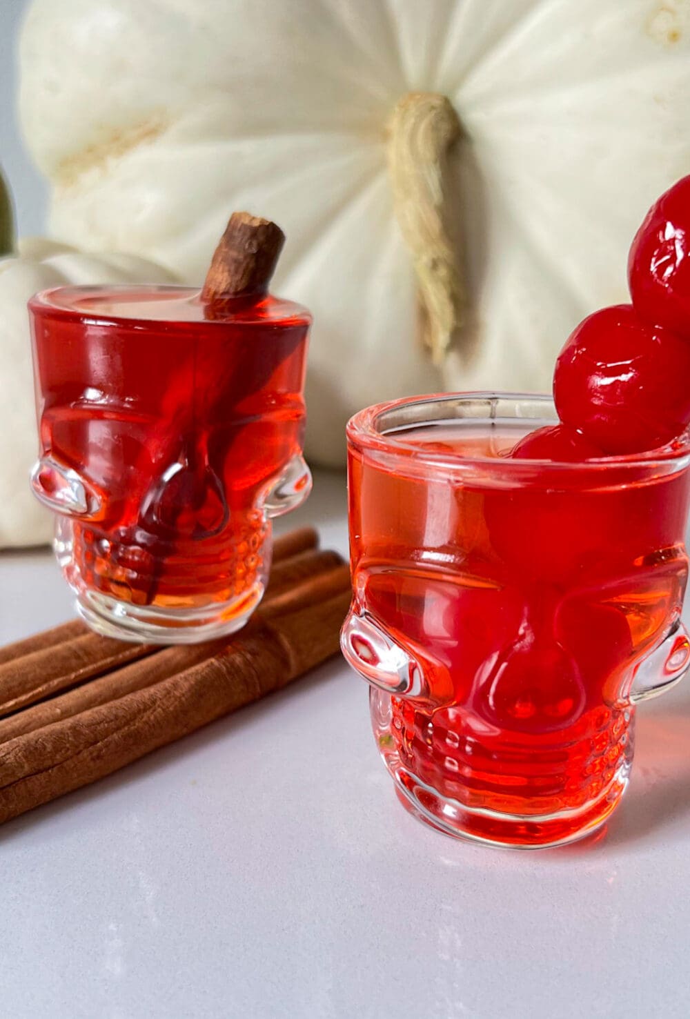 fireball shots in skull glasses with cinnamon sticks and cherries