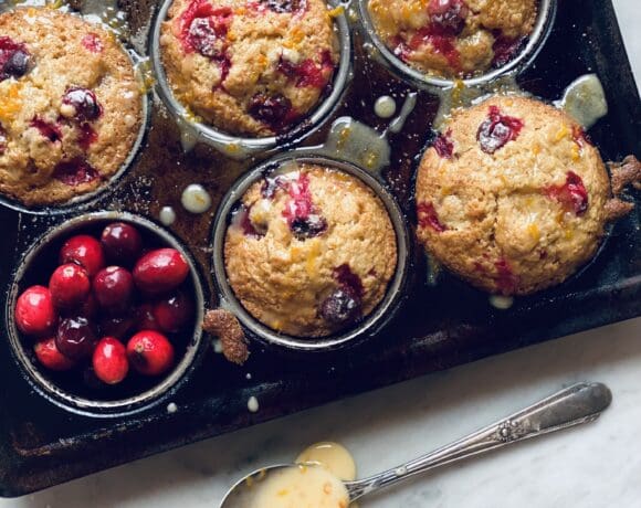 Cranberry orange muffins with glaze in a spoon