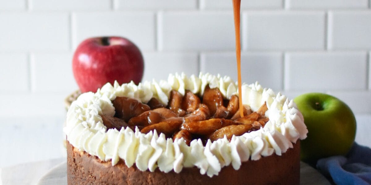 caramel apple cheesecake with caramel being poured on top