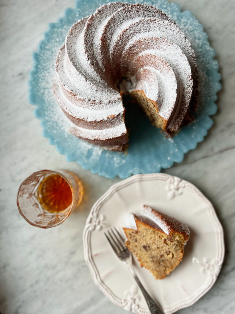 bourbon butter pecan cake with a slice and a glass of bourbon