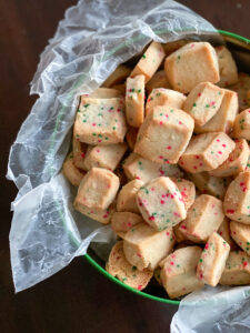 sprinkle funfetti shortbread cookies in a cookie tin