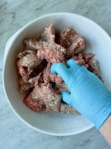 ground beef and breakfast sausage getting mixed together