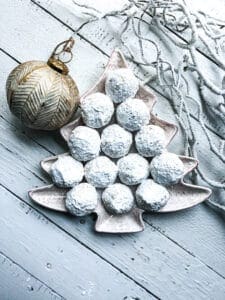 snowballs on a christmas tree plate with an ornament