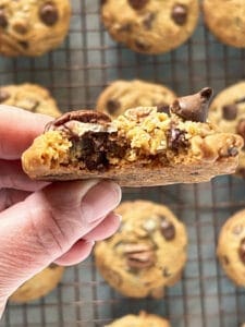 Pecan chocolate chip cookie with bite taken out of it