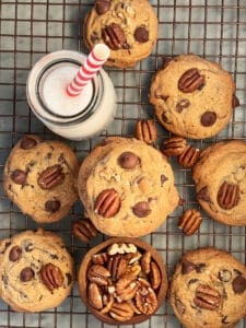 pecan chocolate chip cookies and milk with a straw
