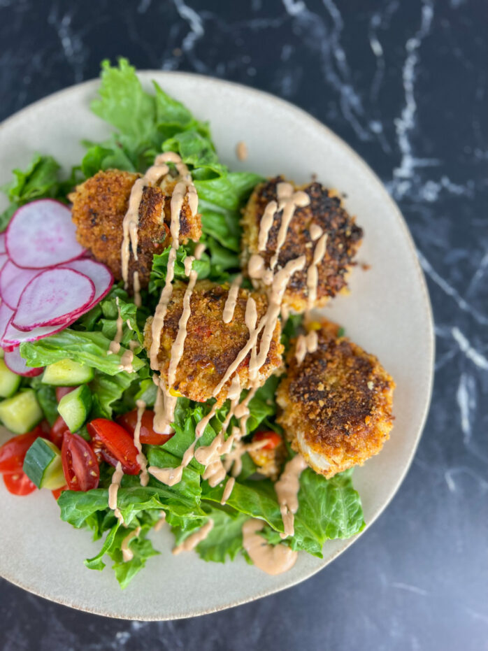 crab cakes on a salad with chipolte mayo