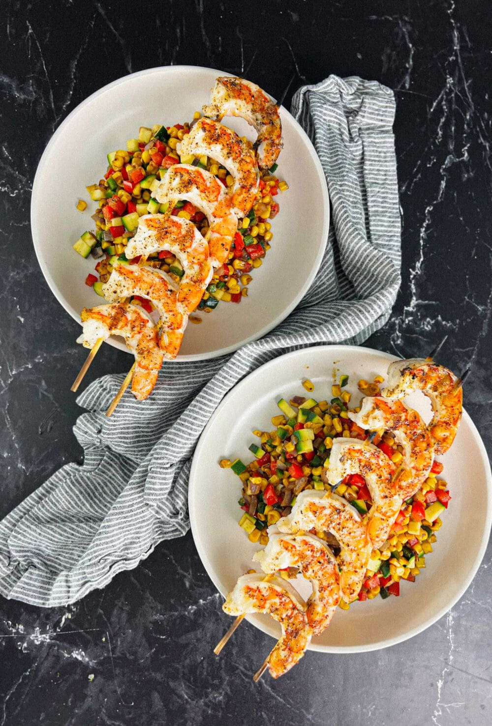 Skewered Shrimp over bowls of veggies