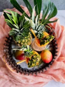 2 Mango Daiquiris on a tray with a pineapple