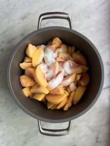 peaches in a pot un-cooked with sugar on top