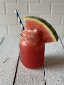 watermelon martini mocktail in a mason glass with a straw