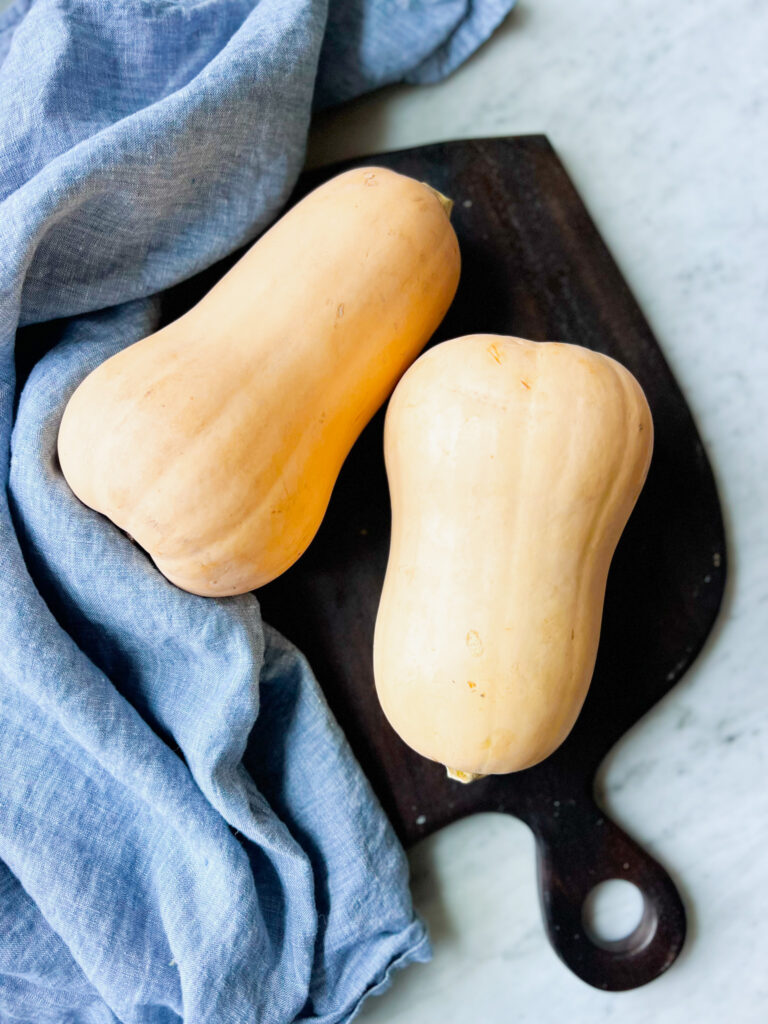 Whole butternut squash and a blue napkin