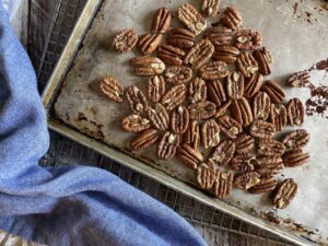 roasted pecans on a baking sheet