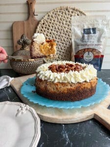 Caramel pecan cheese cake side view of cut slice with pearson pecan bag