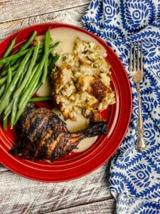 Old fashioned Thanksgiving Dressing or Stuffing and green beans and a turkey leg