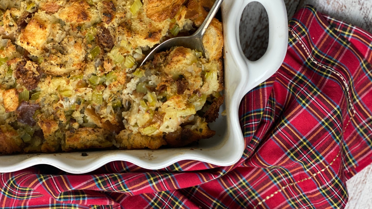 Old fashioned dressing in a white pan with a red plaid napkin