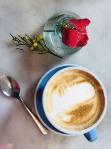 espresso in a cup with a rose and a spoon