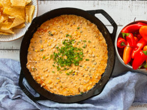 corn and cream cheese dip with chips and peppers