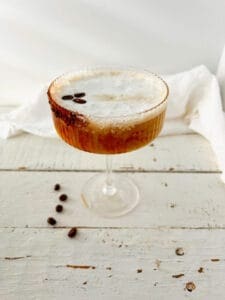 Hazelnut Espresso Martini with coffee beans on top and on the side