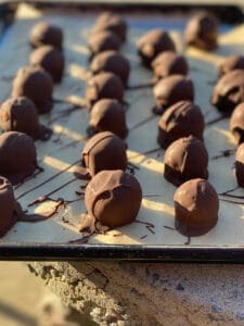 old-fashioned peanut butter balls coated in chocolate cooling outside