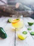 skinny spicy margarita with dried citrus wedge and jalapeño on top