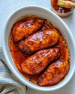 4 bbq chicken breasts in an oval white pan