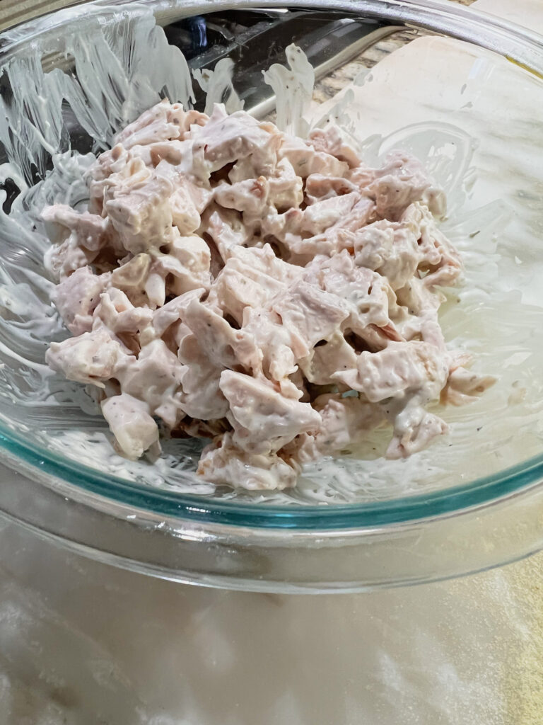 chicken and ranch dressing mixed in a bowl