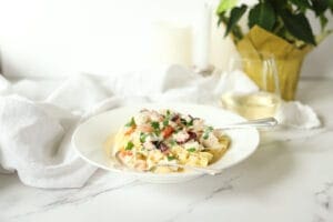 Seafood alfredo in a dish with a glass of white wine-dinner for 2