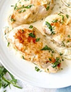 Creamy tarragon chicken on a plate with herbs
