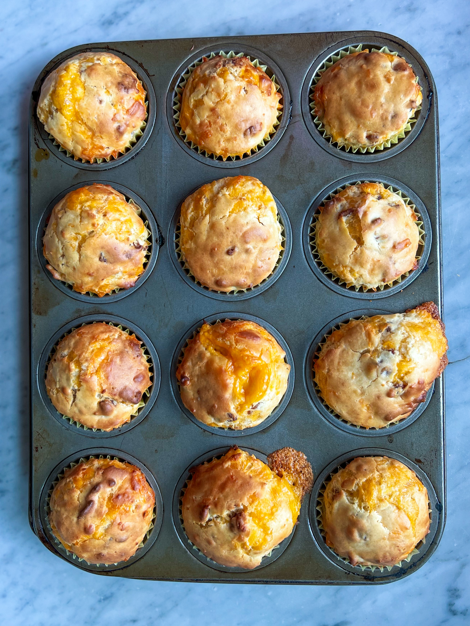 baked bacon cheese muffins in a muffin tim