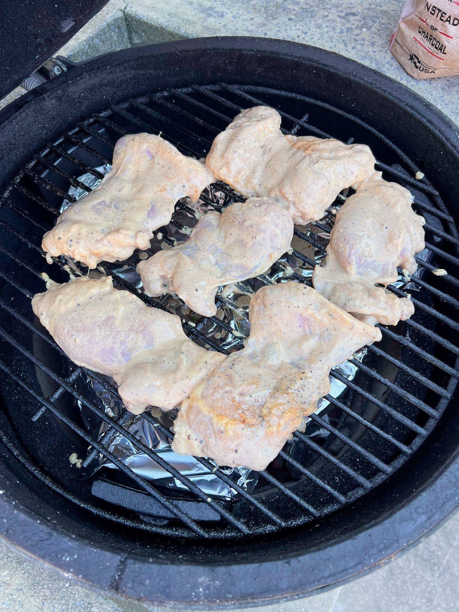 raw chicken thighs on a grill