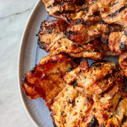 Blue platter of smoked chicken thighs