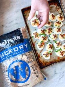 Bag of Western BBQ Hickory wood smoking chips and Smoked Deviled Eggs with Smoked Bacon Candy and Green onions